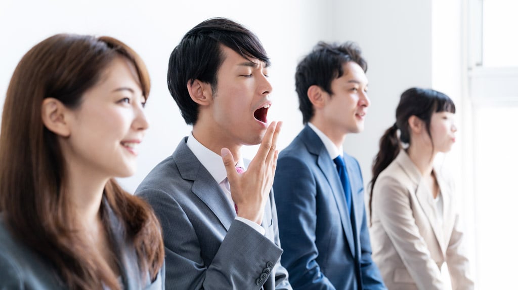 会議中退屈そうにしているビジネスマン